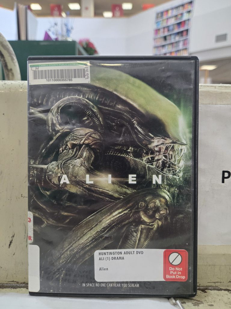 Alieve dvd case with barcode and info from cabell county public library sitting on checkout cart